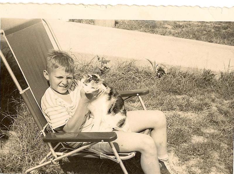 Young David wearing a polashirt choking Checkers the calico. DAVE FREDERICK PHOTOS